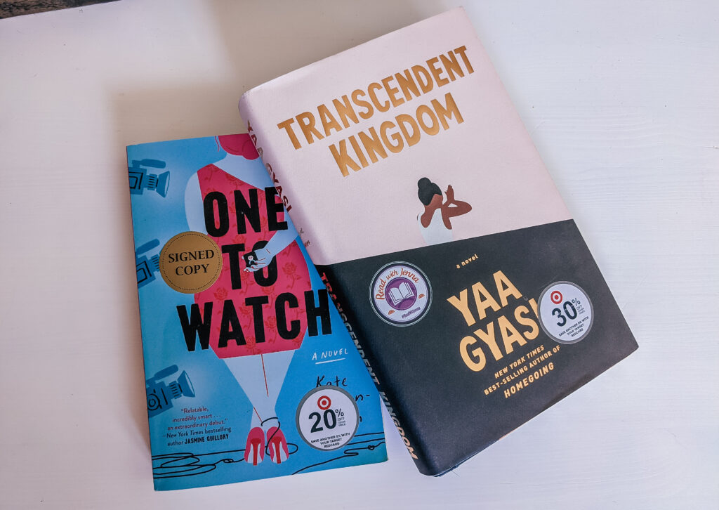 Summer Reading books One to Watch by Kate Stayman-London and Transcendent Kingdom by Yaa Gyasi placed on a smooth, white wood table.